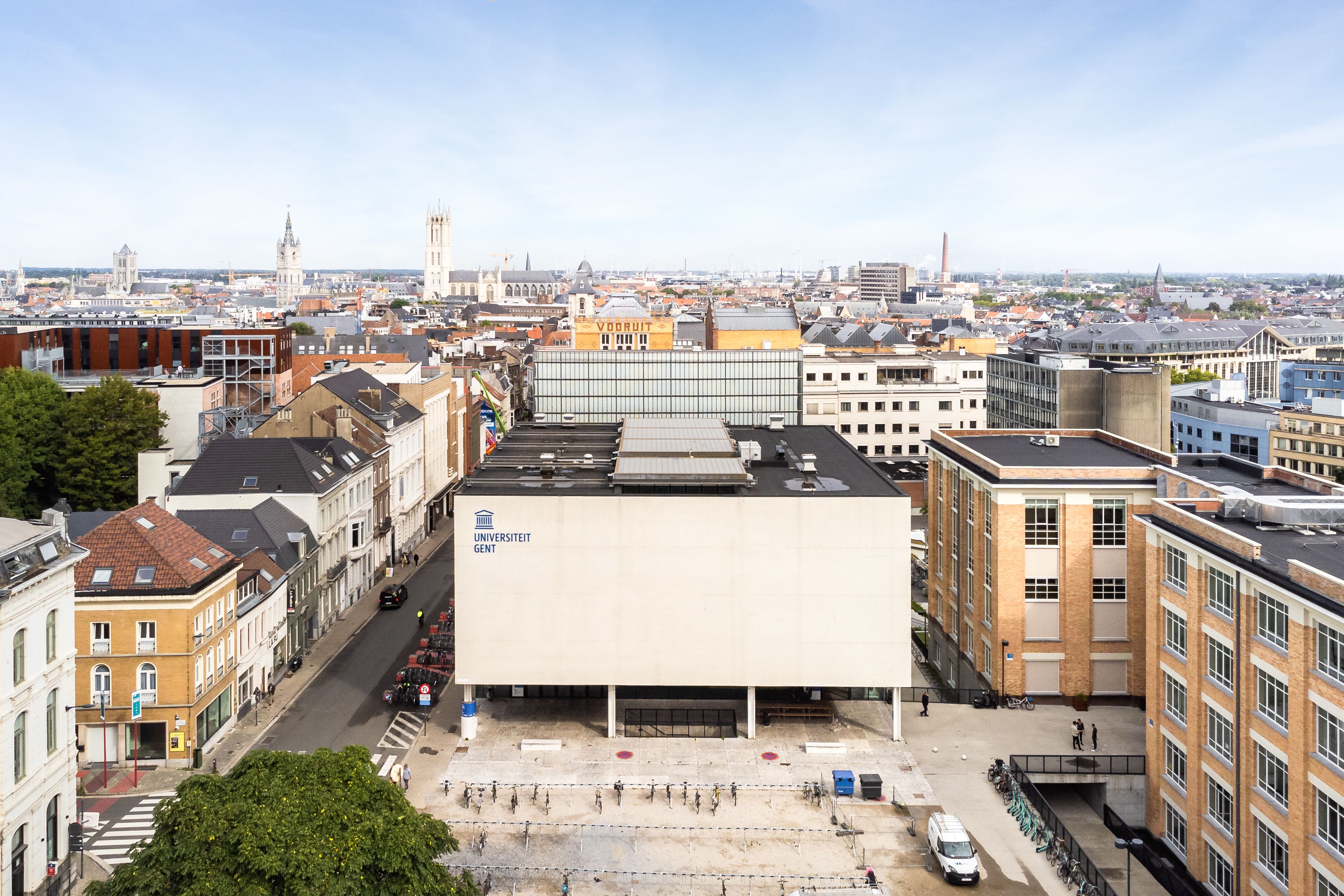 Aerial view of Ghent University's Plateau campus with the historic city skyline beyond.